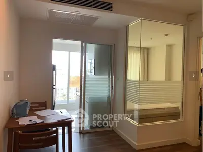 Modern apartment interior with glass partition and balcony view