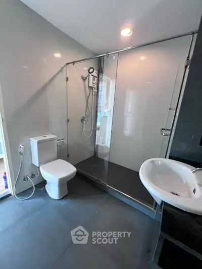 Modern bathroom with glass shower and sleek fixtures