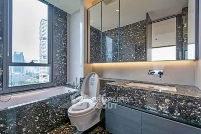 Luxurious bathroom with city view and elegant marble finishes.