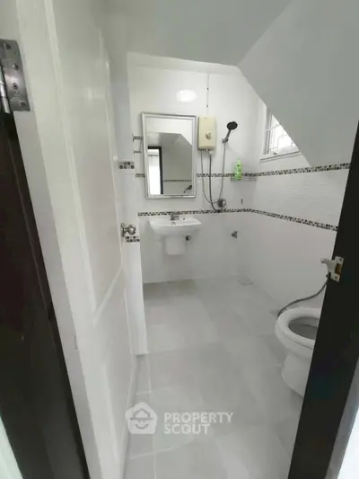 Modern minimalist bathroom with sleek fixtures and neutral tiles