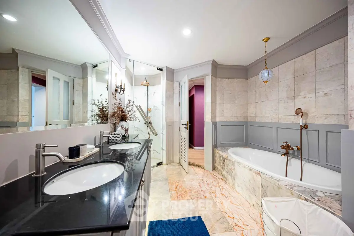 Luxurious bathroom with double sinks and elegant bathtub in modern home.