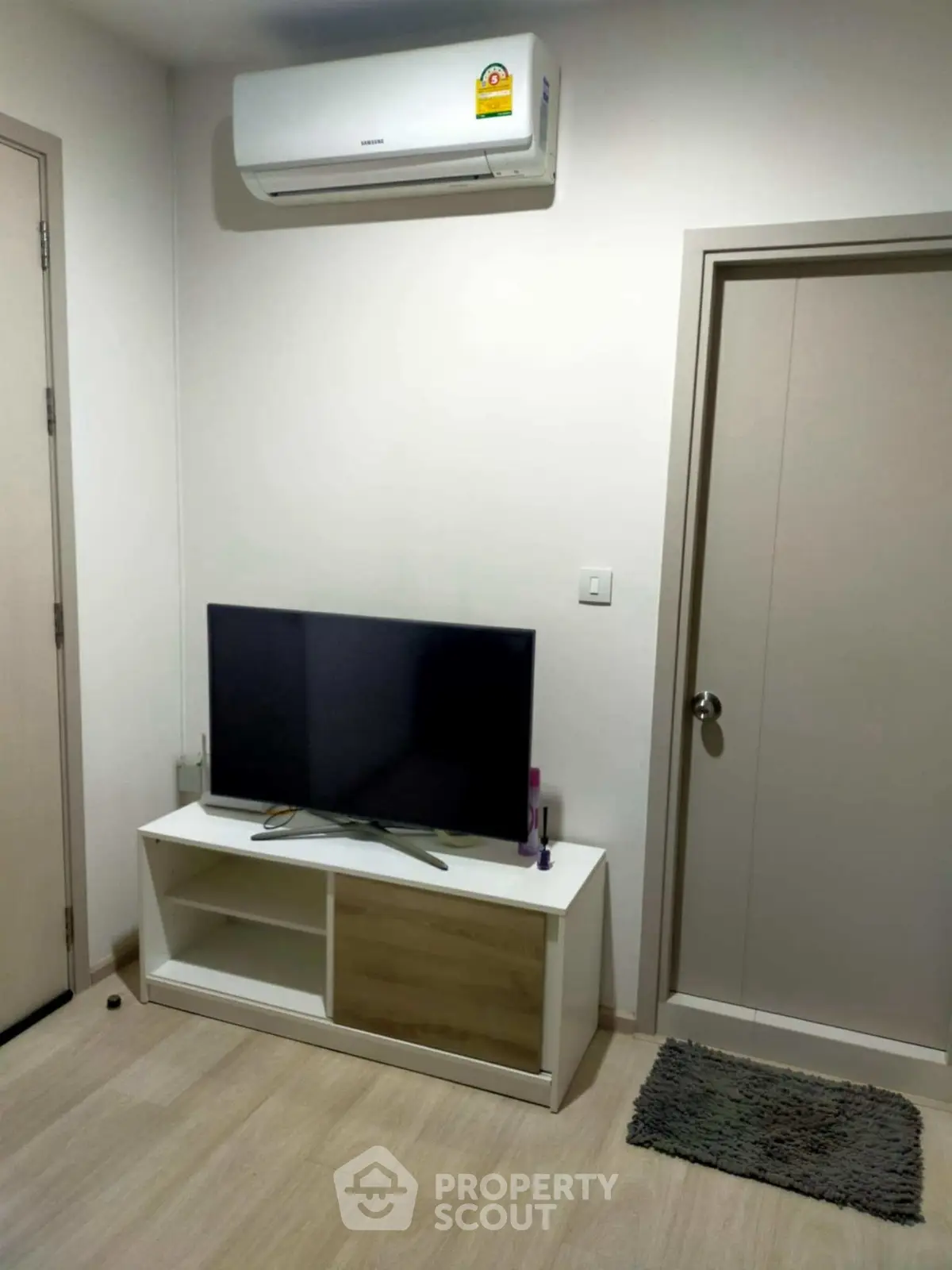 Modern living room with air conditioning and sleek TV setup