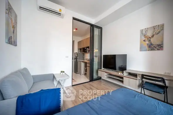 Modern living room with stylish decor and open kitchen layout in a cozy apartment.