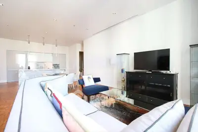 Spacious modern living room with open kitchen and stylish decor