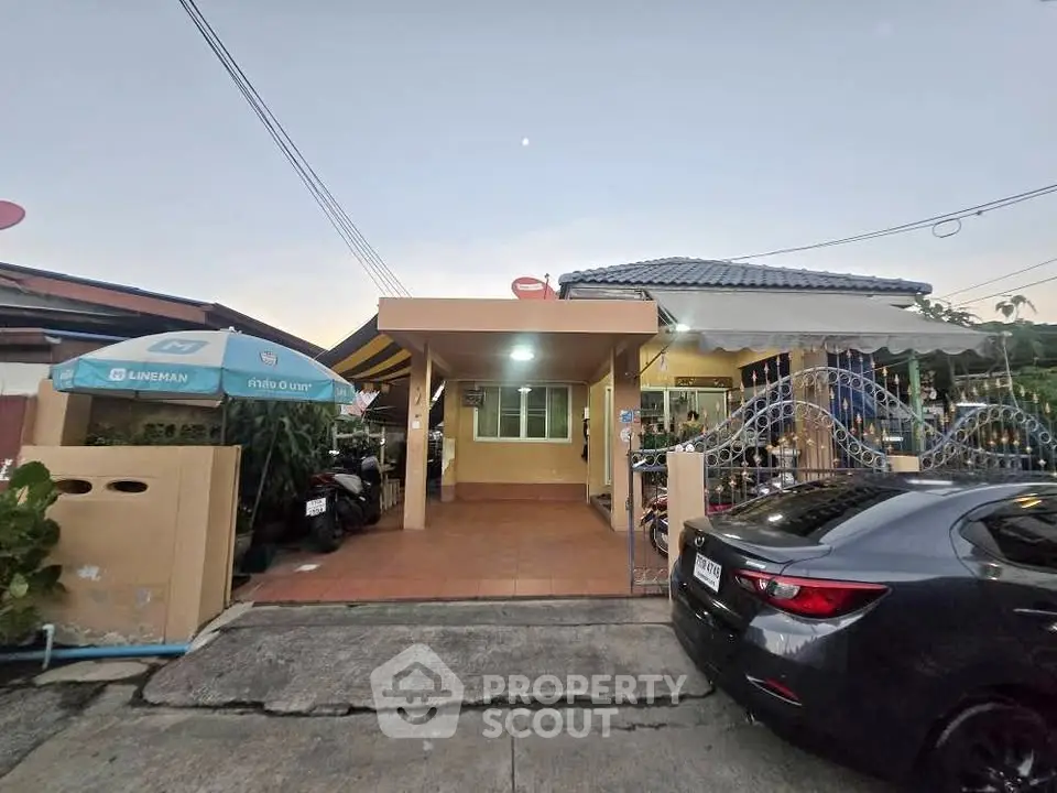 Charming single-story home with covered carport and gated entrance in a serene neighborhood.