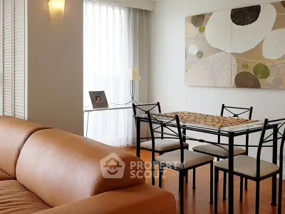 Modern living room with stylish dining area and contemporary artwork, featuring a cozy leather sofa and elegant decor.