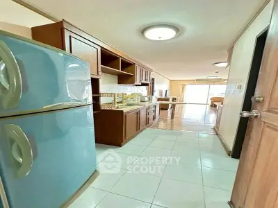 Spacious kitchen with modern appliances and open layout leading to a bright living area.