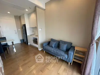 Modern living room with cozy sofa and open kitchen layout