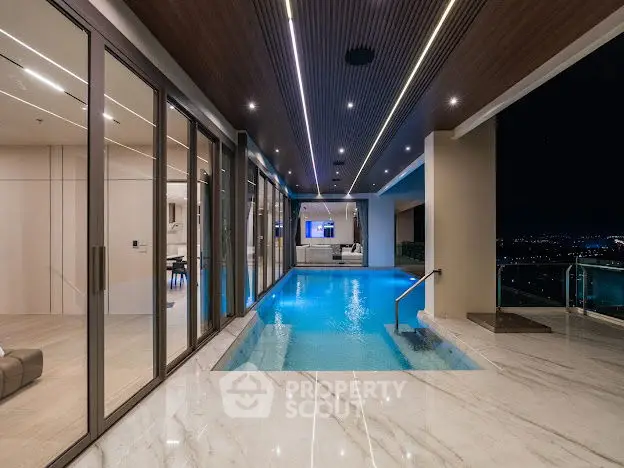 Luxurious indoor pool with stunning night city view and modern lighting