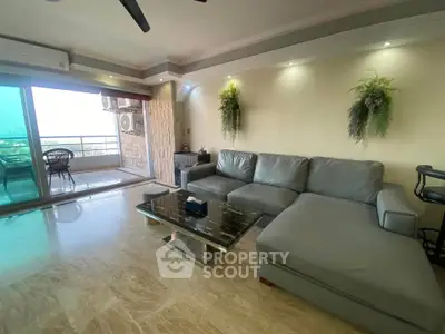 Spacious living room with modern decor and balcony view