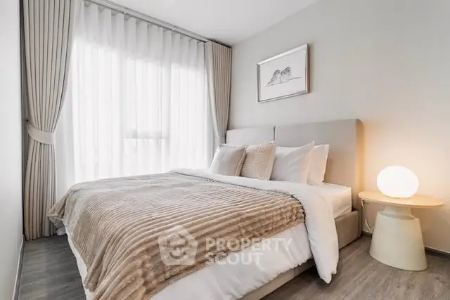 Elegant bedroom with cozy bedding and soft lighting, perfect for relaxation and comfort.