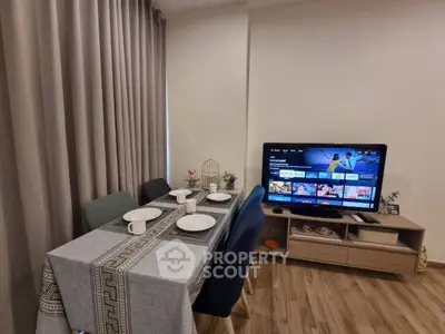 Modern living room with dining area and TV setup, perfect for cozy gatherings.