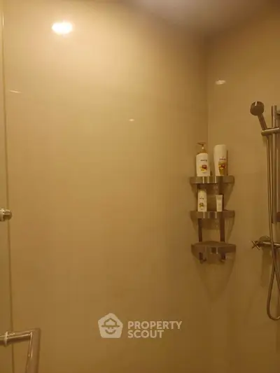 Modern bathroom shower area with sleek fixtures and neutral tiles