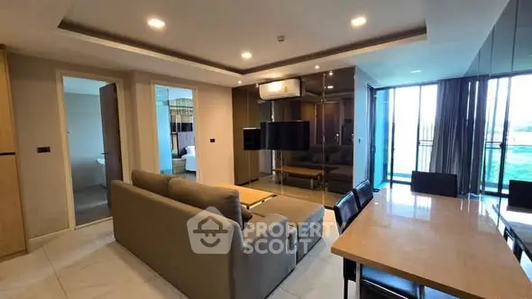 Spacious modern living room with dining area and balcony view in luxury apartment.