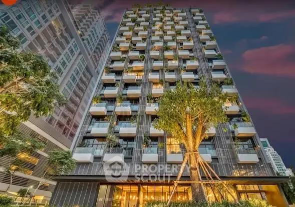 Stunning modern building with lush greenery and unique architectural design.