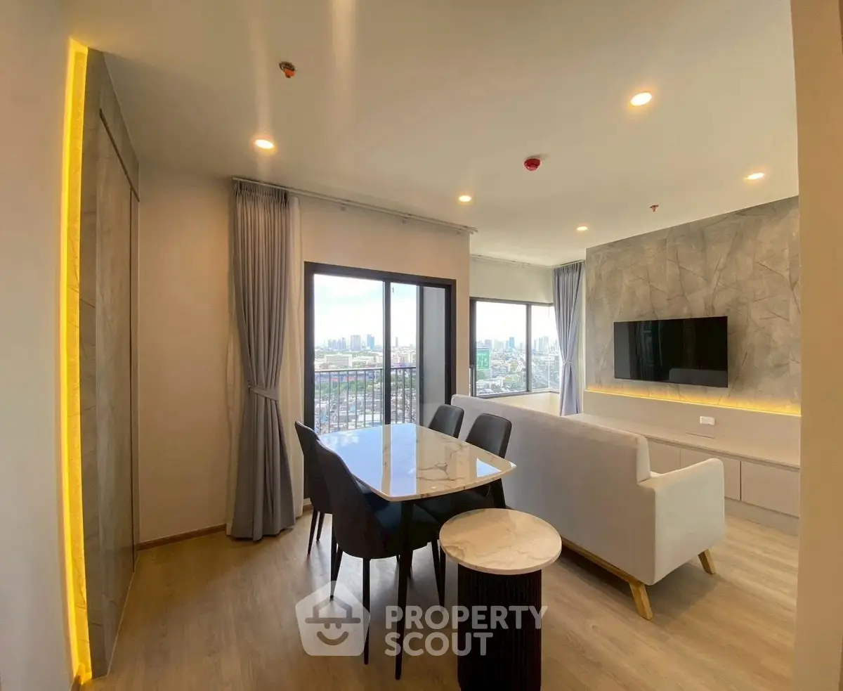 Modern living room with city view, sleek furniture, and stylish decor