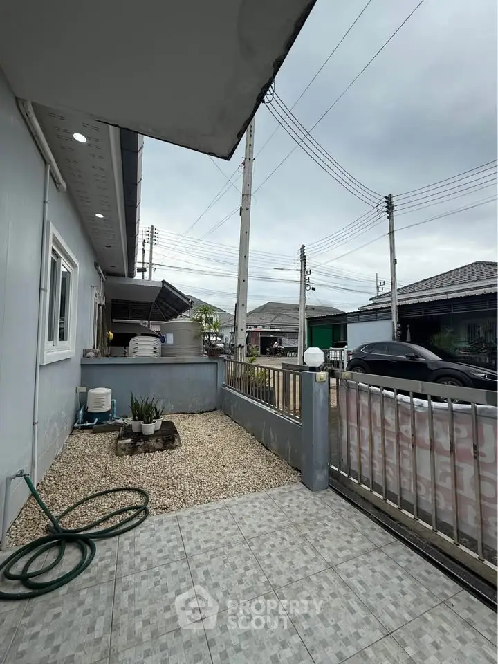 Charming residential exterior with tiled patio and gravel garden area