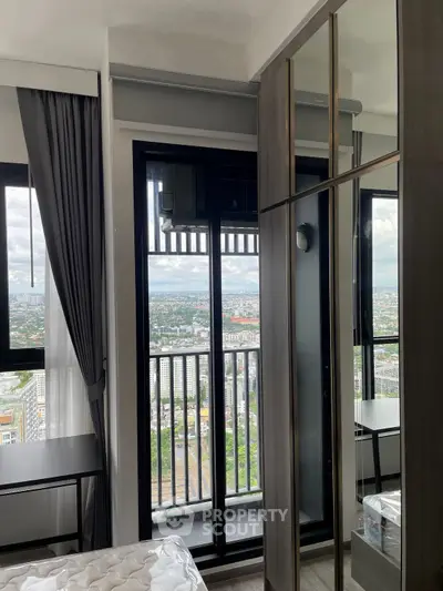 Modern bedroom with balcony and stunning city view in high-rise apartment