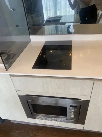 Modern kitchen with sleek built-in appliances and induction cooktop.