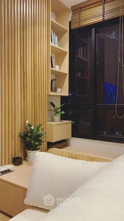 Modern bedroom with wooden accents and large window offering city view