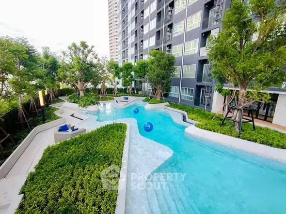 Luxurious apartment complex with stunning outdoor pool and lush greenery.