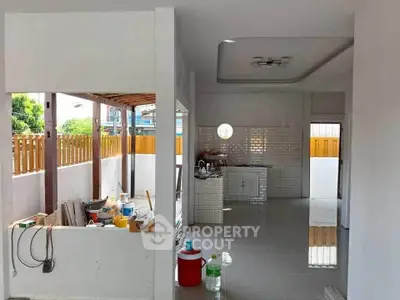 Spacious open-plan kitchen with modern design and ample natural light, perfect for family gatherings.