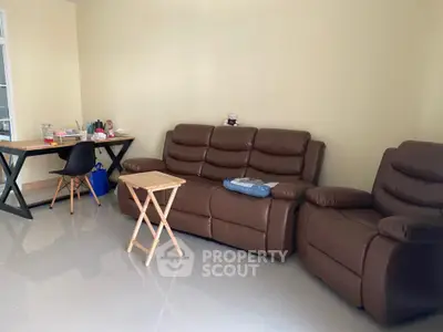 Cozy living room with leather sofa and modern workspace