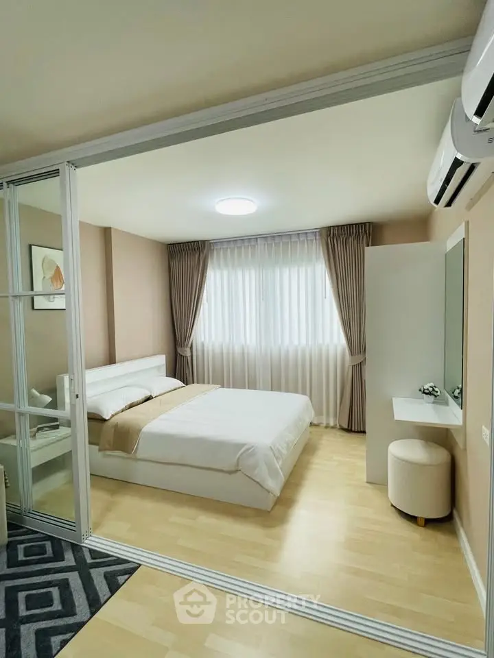 Modern bedroom with elegant decor and natural light, featuring a cozy bed and stylish furnishings.
