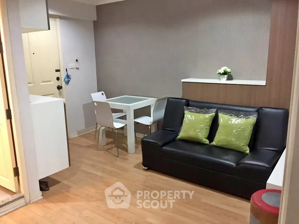 Cozy living room with modern decor and dining area in a stylish apartment.