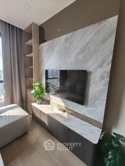 Modern living room with stylish TV setup and natural light