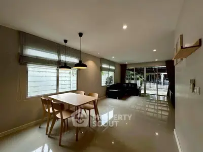 Spacious modern living room with dining area and large windows for natural light.