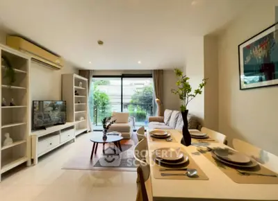 Spacious modern living room with dining area and large windows for natural light.