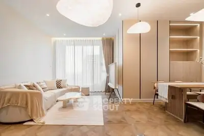 Elegant modern living room with stylish furniture and large window for natural light.