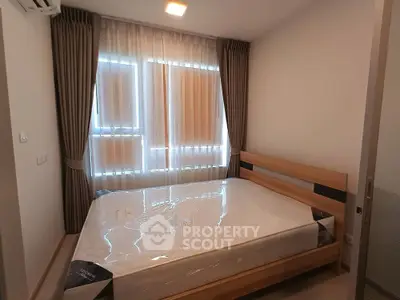 Cozy bedroom with natural light and modern furnishings, perfect for relaxation.