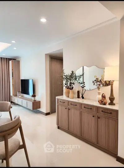 Elegant living room with modern decor, featuring a sleek TV unit and stylish sideboard.
