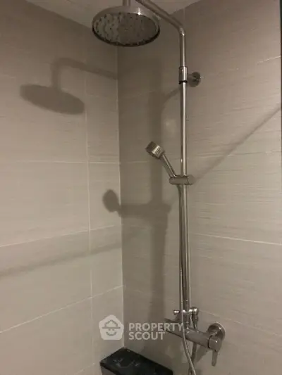 Modern bathroom shower with sleek fixtures and neutral tiles