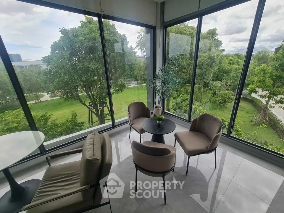 Spacious corner unit with floor-to-ceiling windows offering lush garden views, perfect for relaxation.