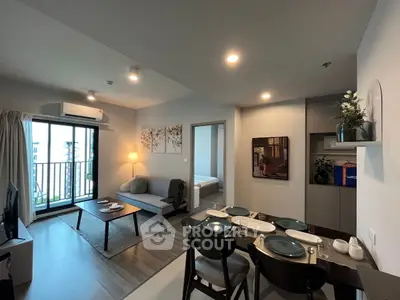 Modern living room with cozy dining area and balcony view