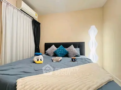 Cozy bedroom with plush bedding, stylish pillows, and modern lighting