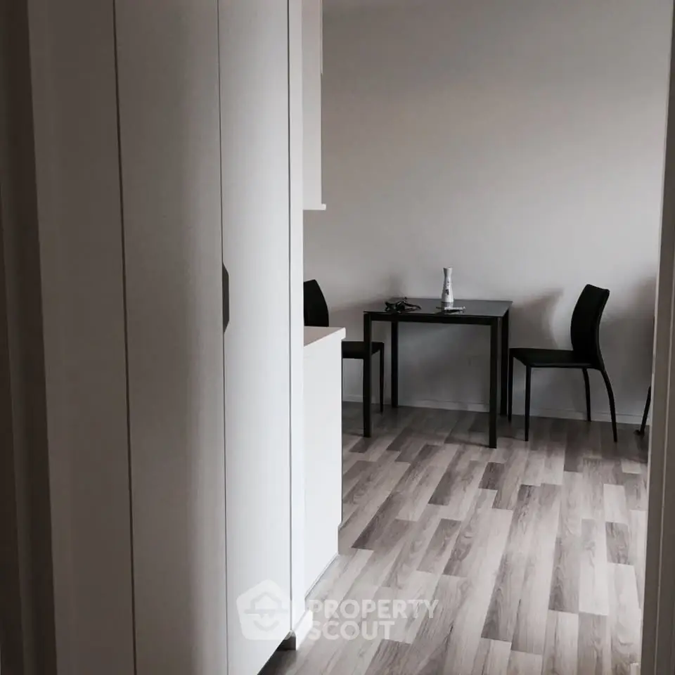 Modern minimalist dining area with sleek furniture and wooden flooring