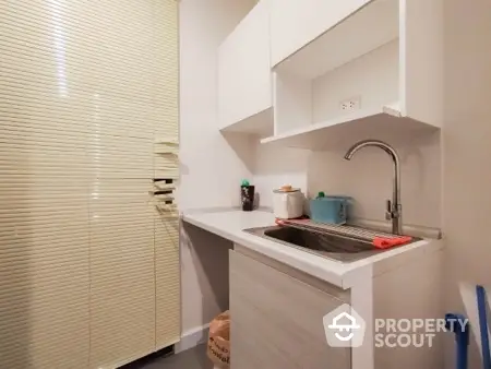 Compact kitchen with modern sink and storage cabinets