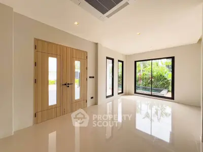 Spacious modern living room with large windows and garden view
