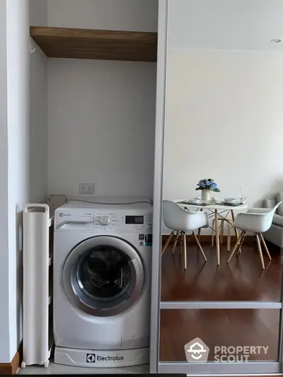 Modern apartment interior with washing machine and stylish dining area