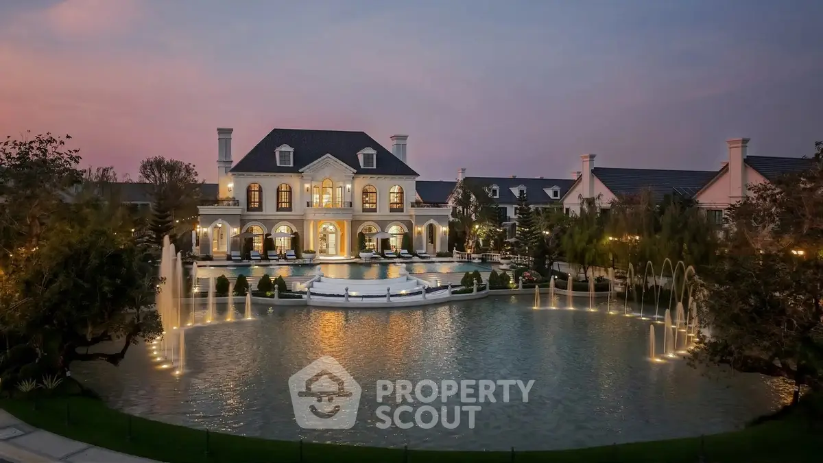 Luxurious mansion with elegant architecture and stunning illuminated fountains at dusk.