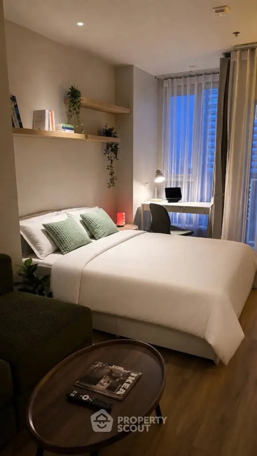 Cozy modern bedroom with stylish decor and natural light, perfect for relaxation and productivity.
