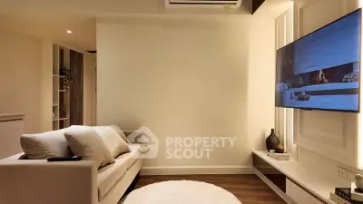 Modern living room with cozy sofa and wall-mounted TV
