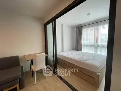 Modern bedroom with glass partition and cozy workspace in urban apartment