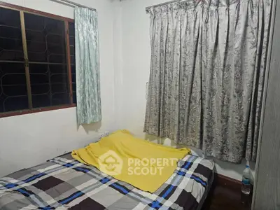 Cozy bedroom with patterned curtains and a comfortable bed, perfect for restful nights.