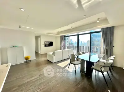 Spacious modern living room with large windows and city view, featuring elegant dining area and stylish decor.