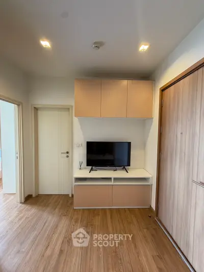 Modern living room with wooden flooring and built-in TV cabinet